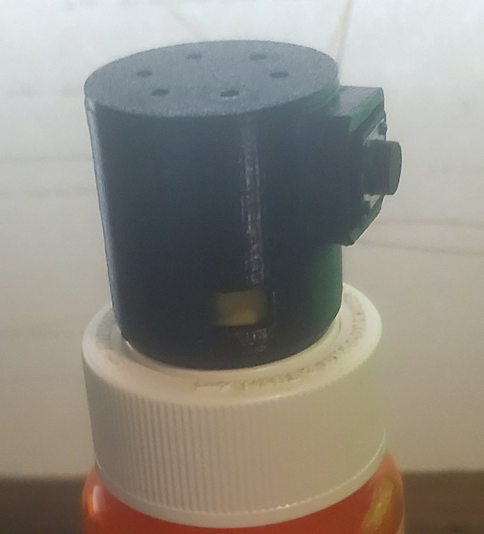 PillPuck on a pill bottle cap